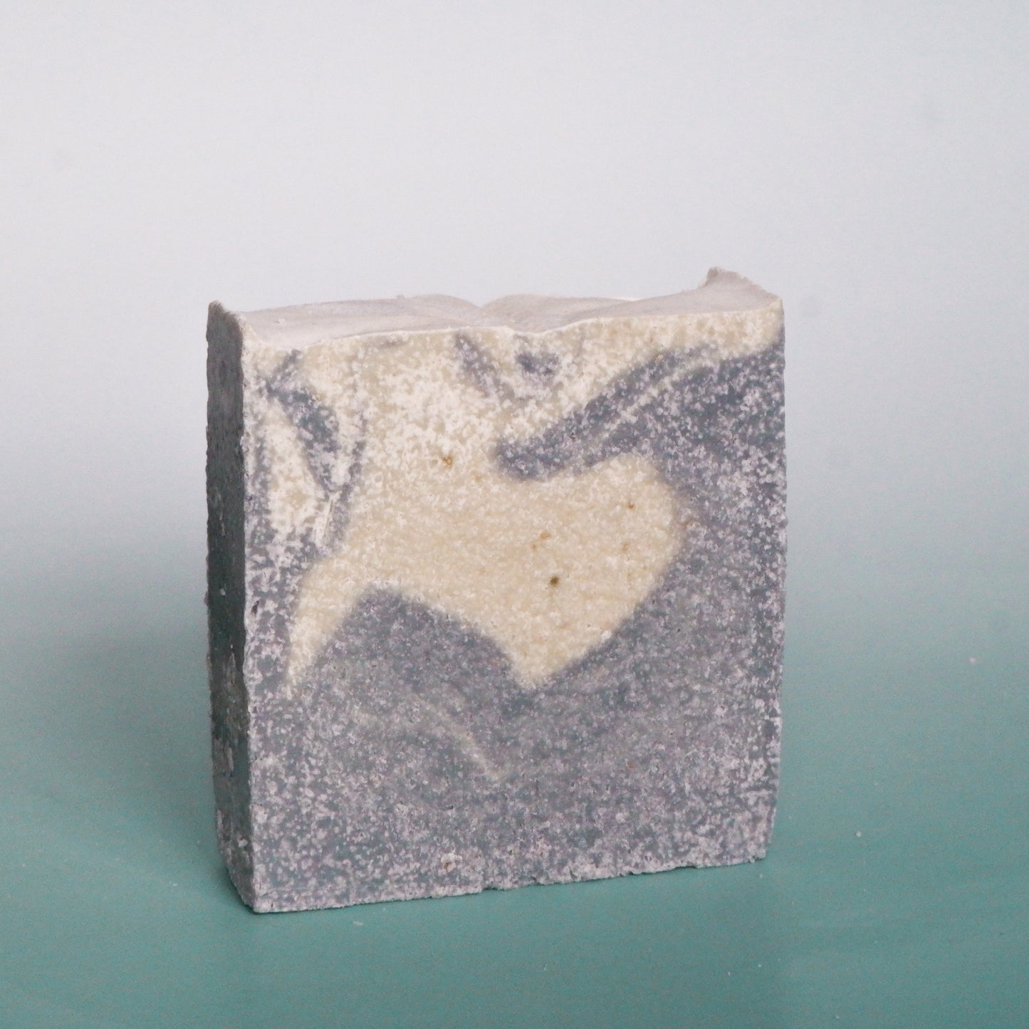 Bar of soap with a heart design on a gradient background