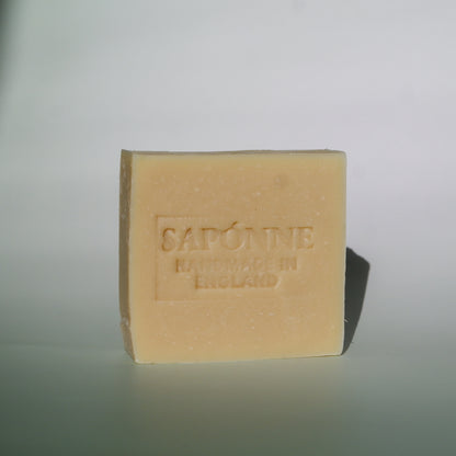 Bar of soap with 'Sapone' branding on a light gray background