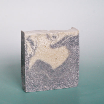 Bar of soap with a heart design on a gradient background