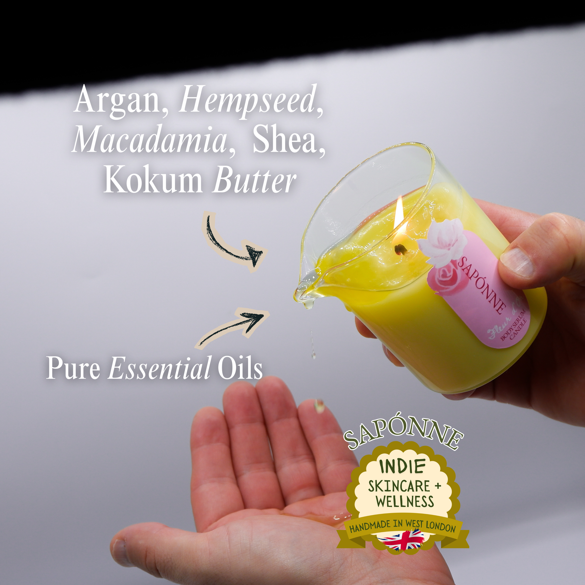 Hand holding a small container of yellow liquid with 'Saponne' branding, showing argan, hempseed, macadamia, shea, and kokum butter ingredients.