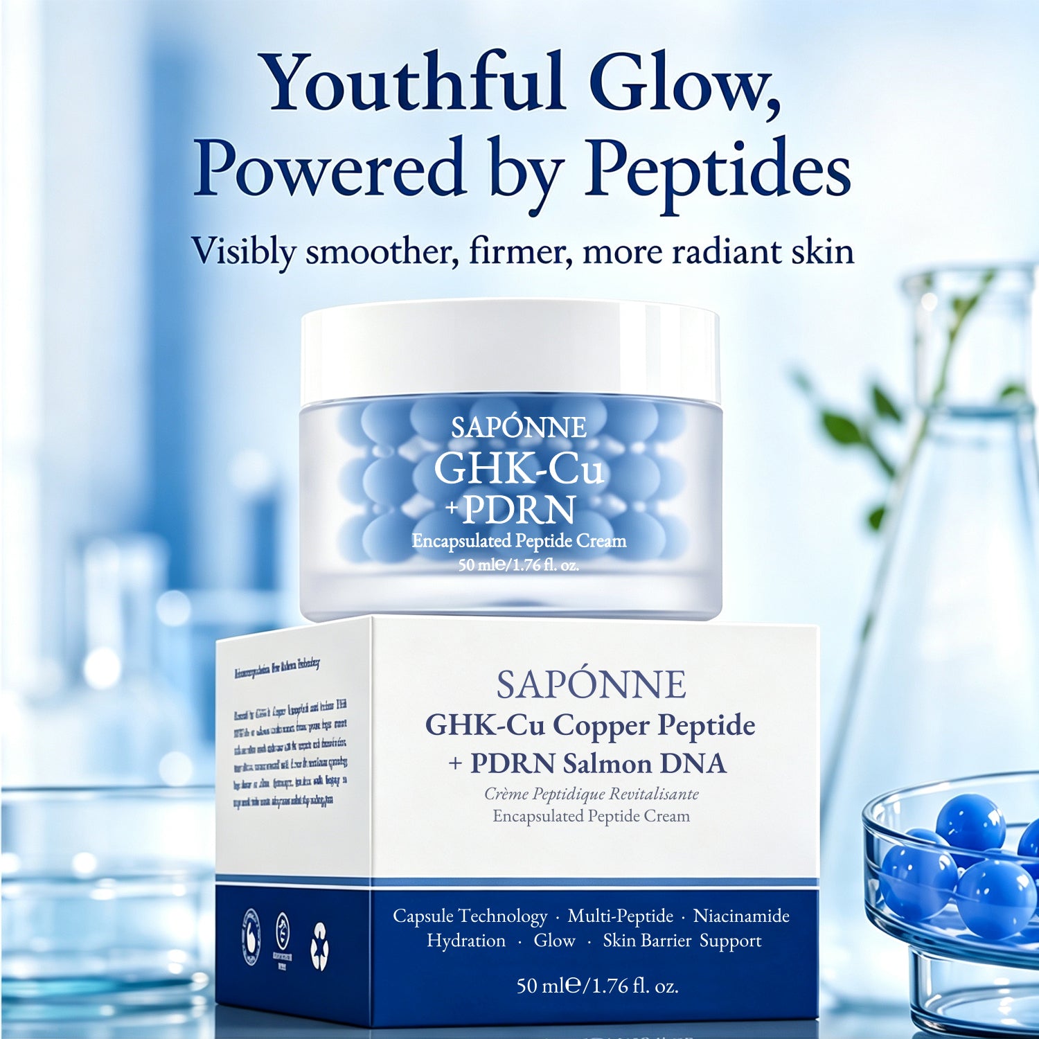 Sapónne GHK-Cu + PDRN Encapsulated Peptide Cream shown in a clear jar with blue gel spheres, placed in front of its white and navy box. The scene is a styled studio setup with a soft blue background, decorative glassware, and text reading 'Youthful Glow, Powered by Peptides.