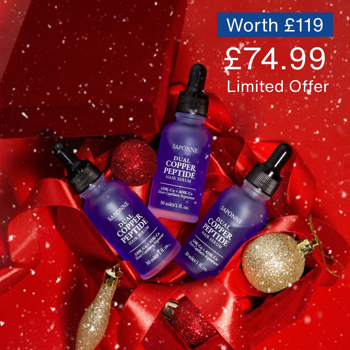 Three purple SABONNE Dual Copper Peptide serum dropper bottles arranged on red ribbon and holiday ornaments with a red snowy backdrop. Blue sale text reads 'Worth £119 £74.