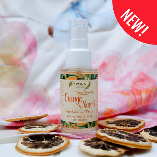 Saponne Orange & Neroli toner bottle with dried orange slices on a floral background