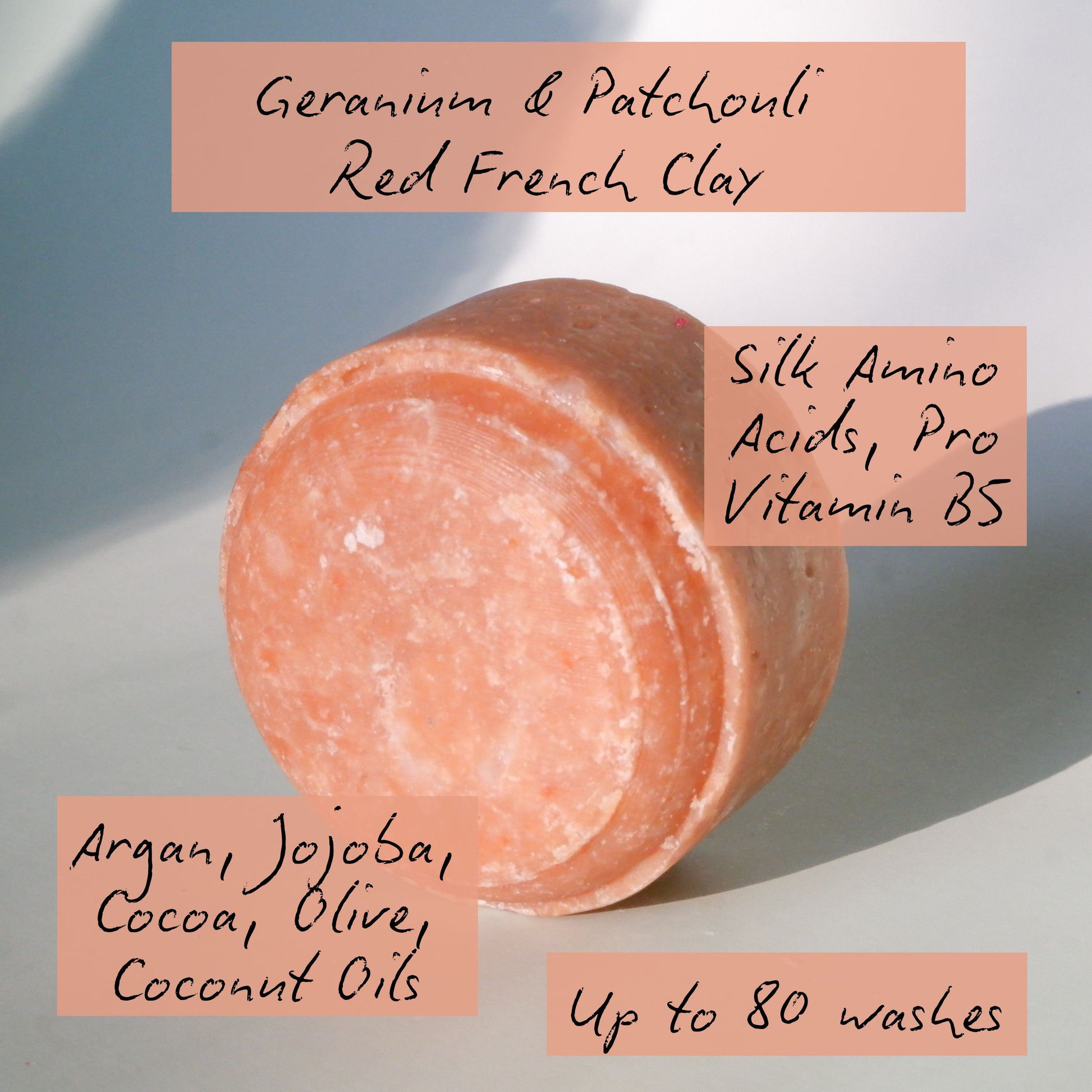Pink bar of soap with text detailing ingredients and benefits on a light background
